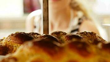 Young woman looking through bakery window video