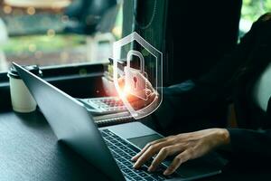 cybersecurity concept Businessmen protecting personal data on laptops and virtual interfaces. Lock icon and internet network security technology. screen padlock and encryption photo