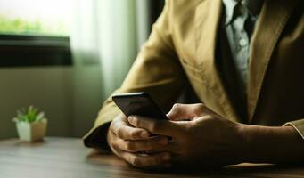 Businessman using mobile phone to open application, reading news, chatting or shopping online, searching information in internet, holding smartphone, internet business, digital marketing photo