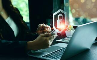 cybersecurity concept Businessmen protecting personal data on laptops and virtual interfaces. Lock icon and internet network security technology. screen padlock and encryption photo