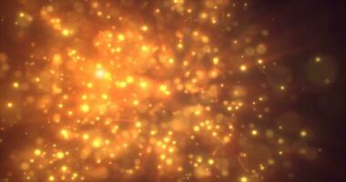 Abstract yellow orange energy particles and dots glowing flying sparks festive with bokeh effect and blur background photo