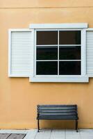 Vintage window on yellow cement photo