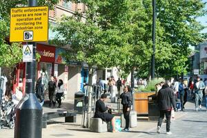 People are Walking at Main Shopping Center of Downtown City Centre of Luton City, England Great Britain UK. Image Captured on June 2nd, 2023 photo