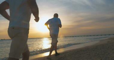 Evening jogging along the beach at sunset video