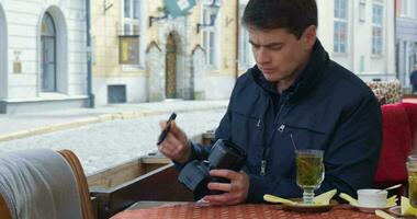 Man Cleaning Camera Lens And Taking Pictures video