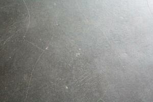 Dark cracked floor surface, shiny deep dark background, grungy floor background photo