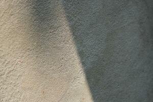 Cement and brick wall texture background, sun rays on the cement wall surface, smooth cement wall backdrop photo