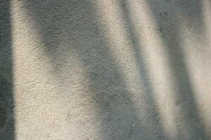 Cement and brick wall texture background, sun rays on the cement wall surface, smooth cement wall backdrop photo