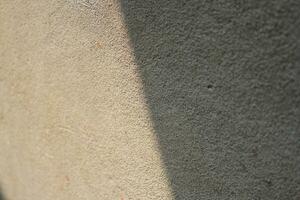 Cement and brick wall texture background, sun rays on the cement wall surface, smooth cement wall backdrop photo