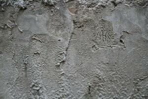 Uneven cement and sand wall texture background, grungy cement wall surface, rustic sand wall photo