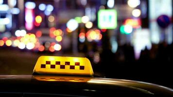 Timelapse of city traffic at night behind taxi sign video