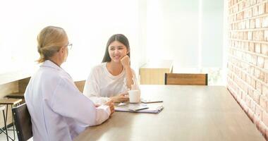 Researchers and scientists talking and drinking coffee at a cafe in their leisure time. photo