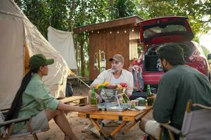 Group tourists drinking beer-alcohol and play guitar together with enjoy and happiness in Summer while camping photo