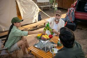 Group tourists drinking beer-alcohol and play guitar together with enjoy and happiness in Summer while camping photo