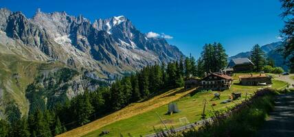 a small airplane is parked on a grassy hillside photo