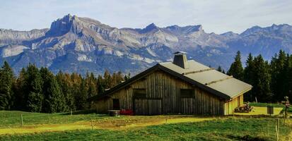 a cabin in the mountains with a mountain range in the background photo