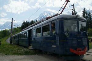 a blue train on the tracks photo