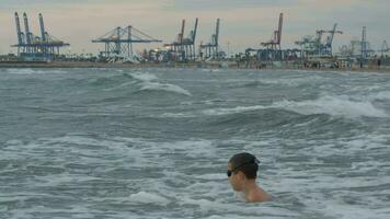 Child fighting with sea waves video