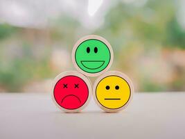 Emotion face wooden block. Customer service rating experience, feedback emotion and satisfaction survey. photo