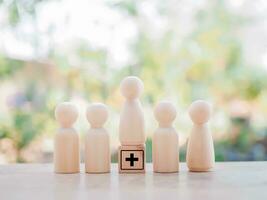 Wooden human figure and wooden block with health care and medical icons set. photo