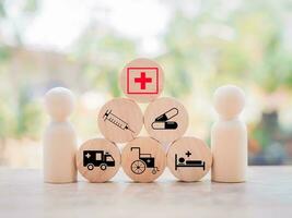 Wooden human figure and wooden block with health care and medical icons set. photo