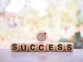 Wooden blocks with the word SUCCESS and business strategy icons for success and winner concept photo