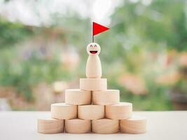 Wooden business figure standing on the podium with red flag, Business competition, Goals, Success and leadership concept photo