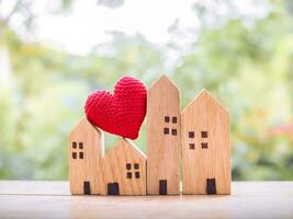 Miniature house with red heart. Investment property concept. photo