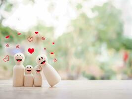 Wooden figure family happy face with heart. The concept of romantic feelings, family relationship. photo