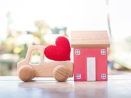 Miniature house, Red heart and wooden toy car. Concept of family photo