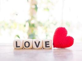 Love on wooden cubes with red heart for Valentine's day concept. photo