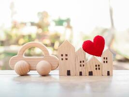 Miniature house, Red heart and wooden toy car. Concept of family photo