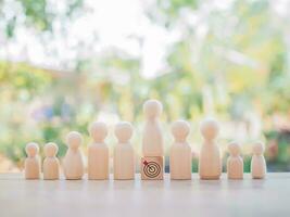 Wooden human figure standing on wooden block with  business strategy icons, Action plan and business process management concept. photo