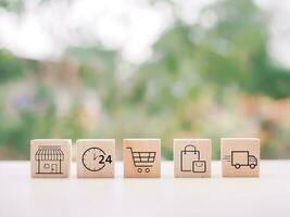 Wooden block with online shopping and e-commerce icons set. photo