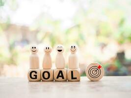 Wooden human figure and wooden blocks with the word GOAL, The concept of business strategy for success and winner concept photo