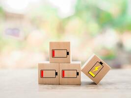 Wooden blocks with status of battery icons. photo