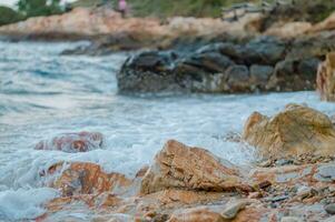 sea waves breaking on rocks with splashes photo