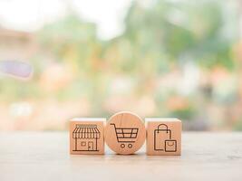 Wooden block with online shopping and e-commerce icons set. photo