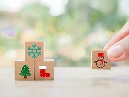 Close up hand arranging Christmas icons for Christmas decorations background. photo