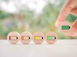 Close up hand arranging green battery full charge. Battery charging icons level, The concept of business, mood, emotion, idea and success. photo