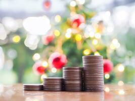 Stack of coins with Christmas light bokeh background. Merry Christmas and Happy New Year, The concept of save money for prepare in new year 2024. photo