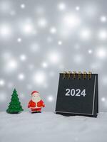 Close up calendar and christmas decoration with shiny light for Christmas and New Year holidays background, Winter season, falling snow, Copy space for Christmas and New Year holidays greeting card. photo