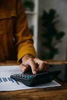Business Man Financial Inspector and Secretary Making Report, Calculating or Checking Balance. Internal Revenue Service Inspector Checking Document Audit Concept photo