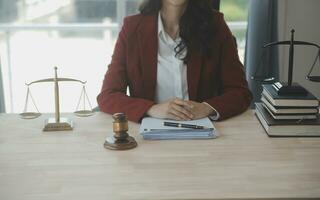 Business and lawyers discussing contract papers with brass scale on desk in office. Law, legal services, advice, justice and law concept picture with film grain effect photo