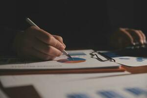Close up businessman hand using calculator and working with laptop calculate about finance accounting at coffeeshop outdor.finance accounting concept photo