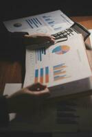 Close up businessman hand using calculator and working with laptop calculate about finance accounting at coffeeshop outdor.finance accounting concept photo