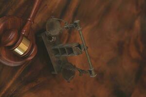 Justice and law concept.Male judge in a courtroom with the gavel, working with, computer and docking keyboard, eyeglasses, on table in morning light photo