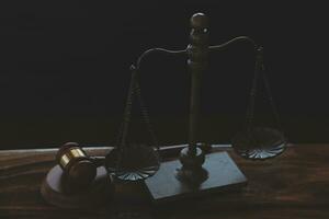 Justice and law concept.Male judge in a courtroom with the gavel, working with, computer and docking keyboard, eyeglasses, on table in morning light photo