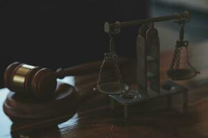 Justice and law concept.Male judge in a courtroom with the gavel, working with, computer and docking keyboard, eyeglasses, on table in morning light photo