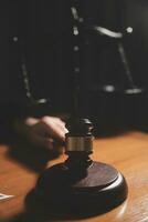 Business and lawyers discussing contract papers with brass scale on desk in office. Law, legal services, advice, justice and law concept picture with film grain effect photo